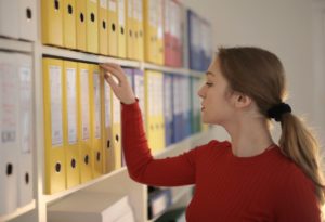 Woman looking at binders