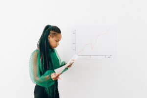 Woman in Green Long Sleeve Shirt Holding White Paper